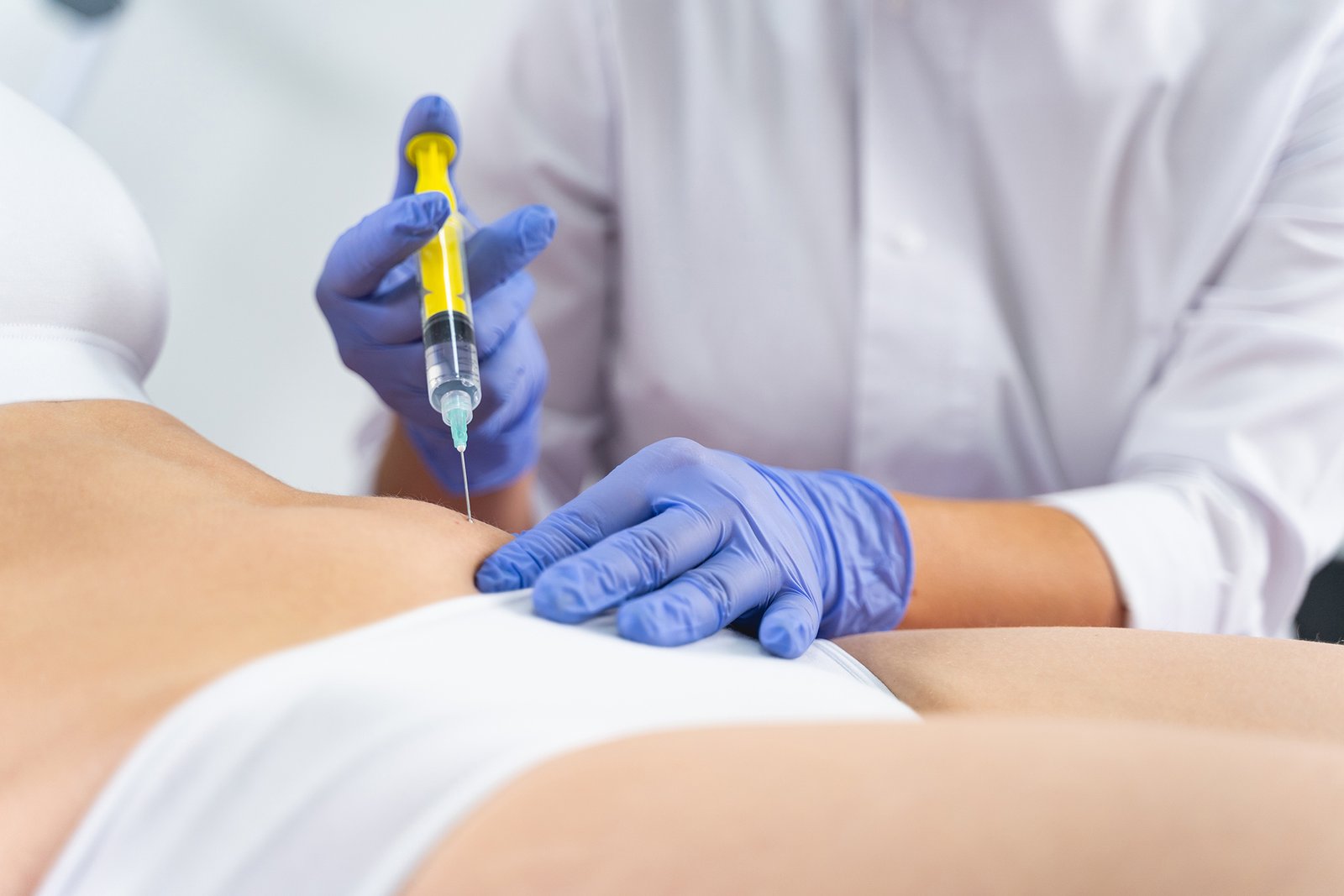 Female patient receiving fat disolving injection